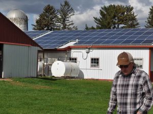 Man walks along solar powered farm