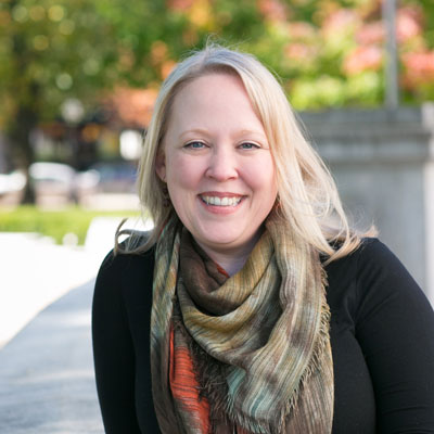 Jodi Jean Amble smiling in front of Wisconsin state capitol building